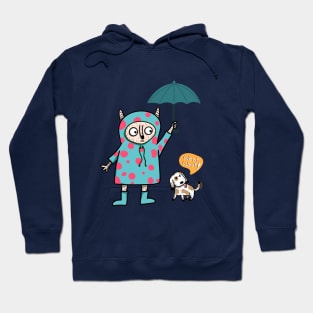 cute-looking monster is holding an umbrella for the dog in the outdoor while heavy rain Hoodie